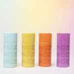 Load image into Gallery viewer, front view of capped Nöz sunscreens in blue, yellow, orange, and purple
