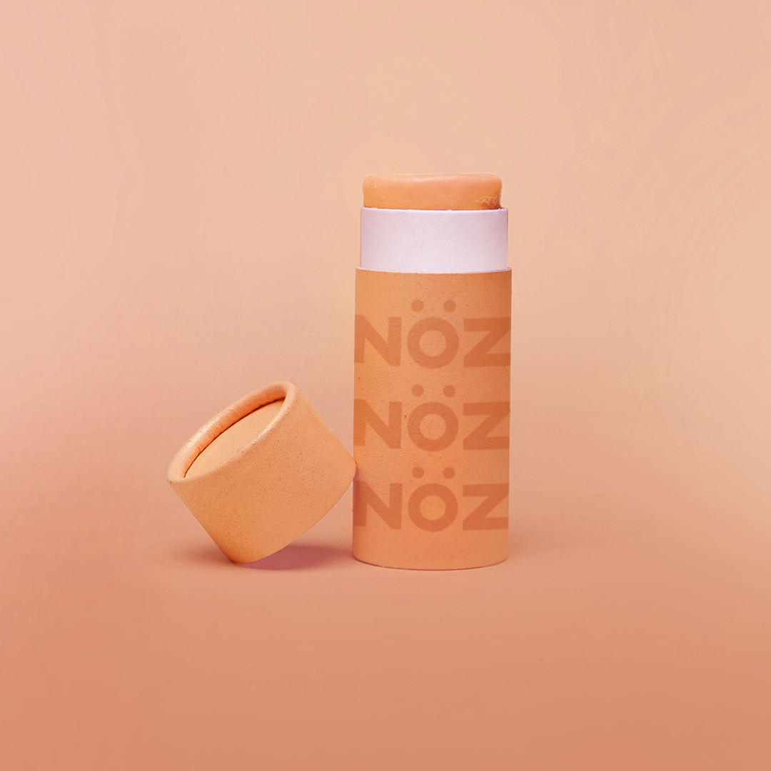 front view of Nöz sunscreen in orange uncapped