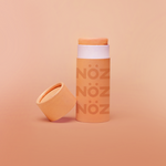 Load image into Gallery viewer, front view of Nöz sunscreen in orange uncapped
